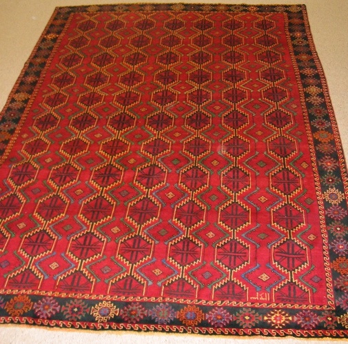 Appraisal: PERSIAN BELOUCHI TRIBAL CARPET repeating columns of hexagonally shaped gols