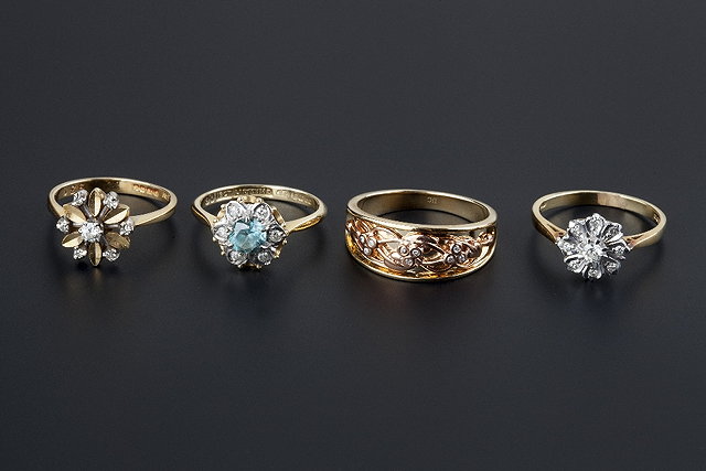 Appraisal: Four diamond set rings comprising a blue zircon and diamond