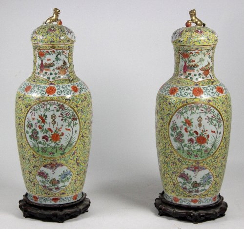 Appraisal: A pair of Cantonese famille rose vases and covers painted