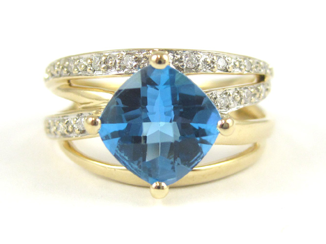 Appraisal: BLUE TOPAZ AND FOURTEEN KARAT GOLD RING with round-cut diamonds