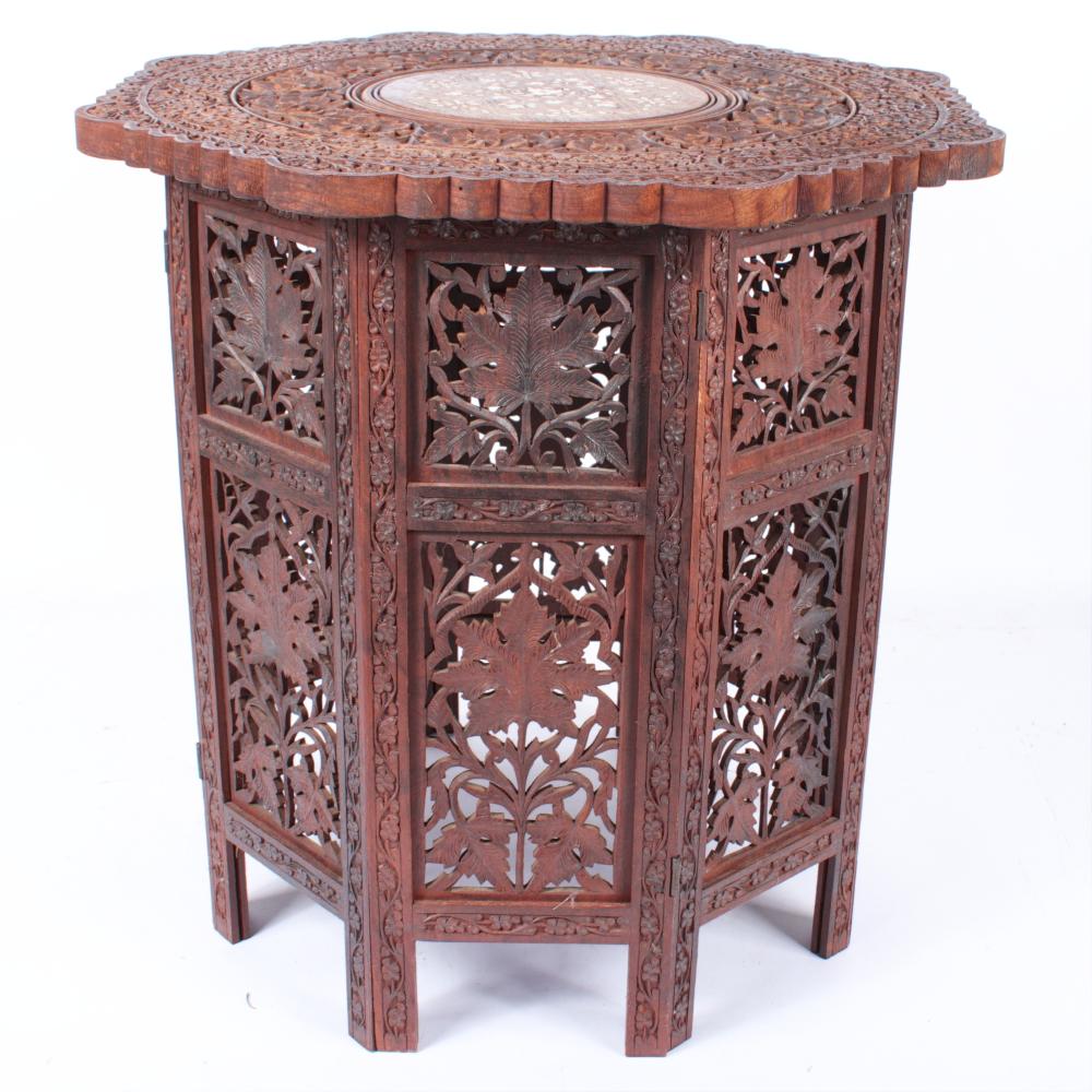 Appraisal: INDO PERSIAN CARVED OCTAGONAL FOLDING TABLE WITH HINGED PANELS AND