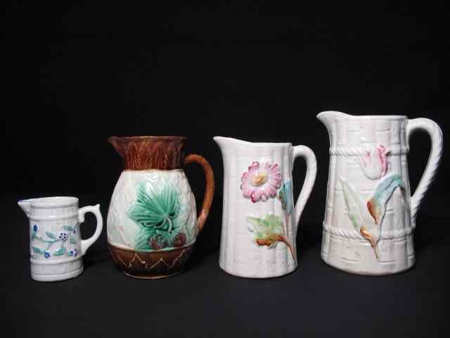 Appraisal: Four Majolica pottery pitchers Includes graduated in sizes in a