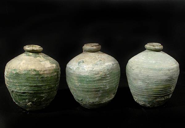 Appraisal: A group of three green glazed terracotta storage jars height