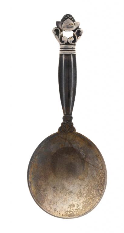 Appraisal: A GEORG JENSEN CADDY SPOON DESIGNED BY JOHAN ROHDE IN