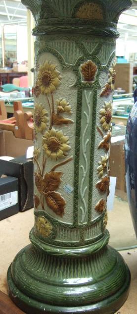 Appraisal: A Burmantofts faience jardiniere stand relief moulded with sunflowers in