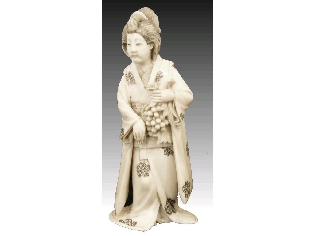 Appraisal: Japanese ivory okimono of a grape picker modelled wearing an