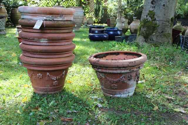 Appraisal: A GROUP OF SIX TERRACOTTA FLOWER POTS with swag decoration