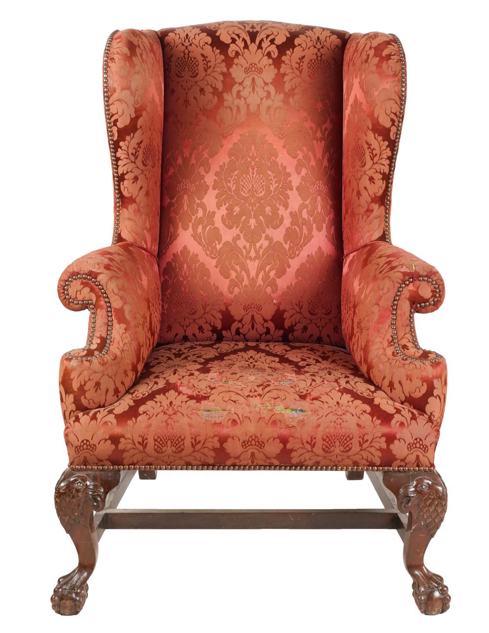 Appraisal: CHIPPENDALE-STYLE WING BACK CHAIRcovered with red damask fabric with nail