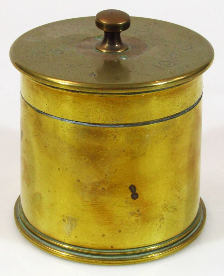 Appraisal: A WWI brass trench art tobacco jar formed from a