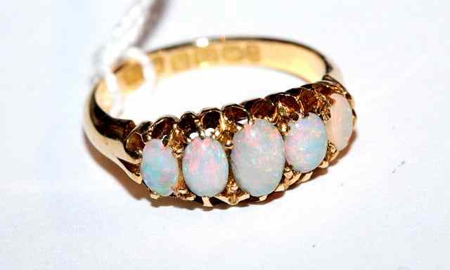 Appraisal: A GRADUATED FIVE STONE OPAL DRESS RING oval stones mounted