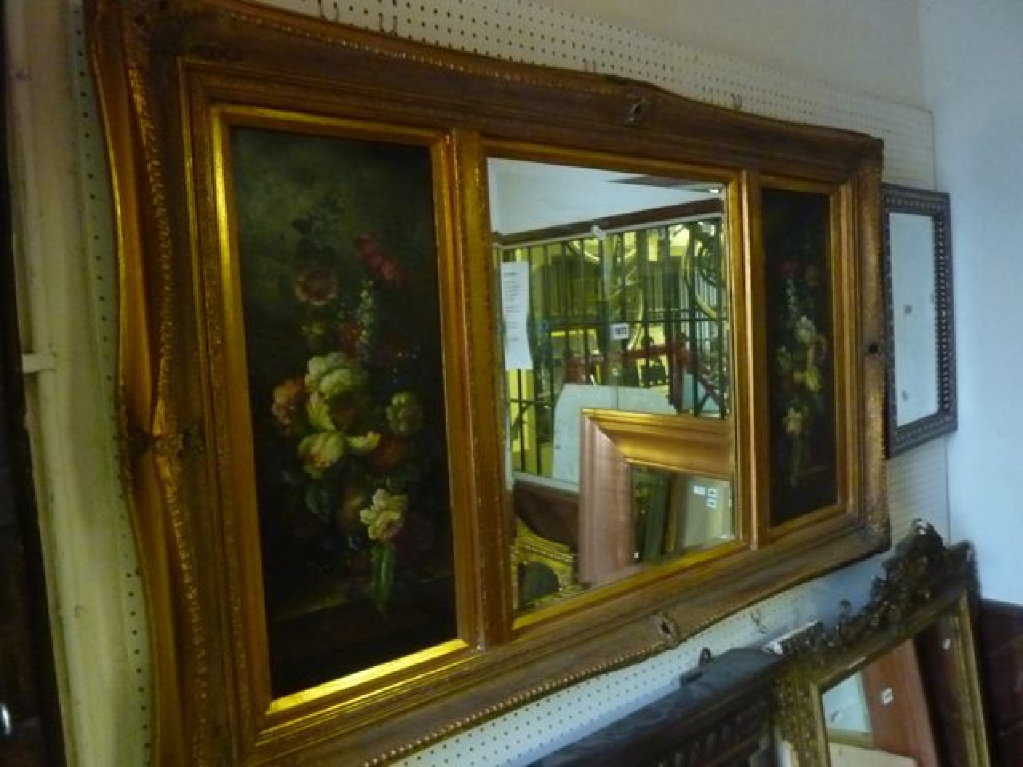 Appraisal: A swept moulded and gilt framed wall mirror the central