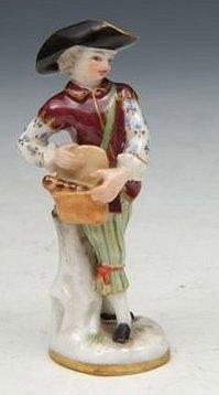 Appraisal: A MEISSEN MINIATURE PORCELAIN FIGURE of a young gentleman carrying