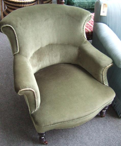 Appraisal: A Victorian armchair with outswept arms over serpentine seat raised