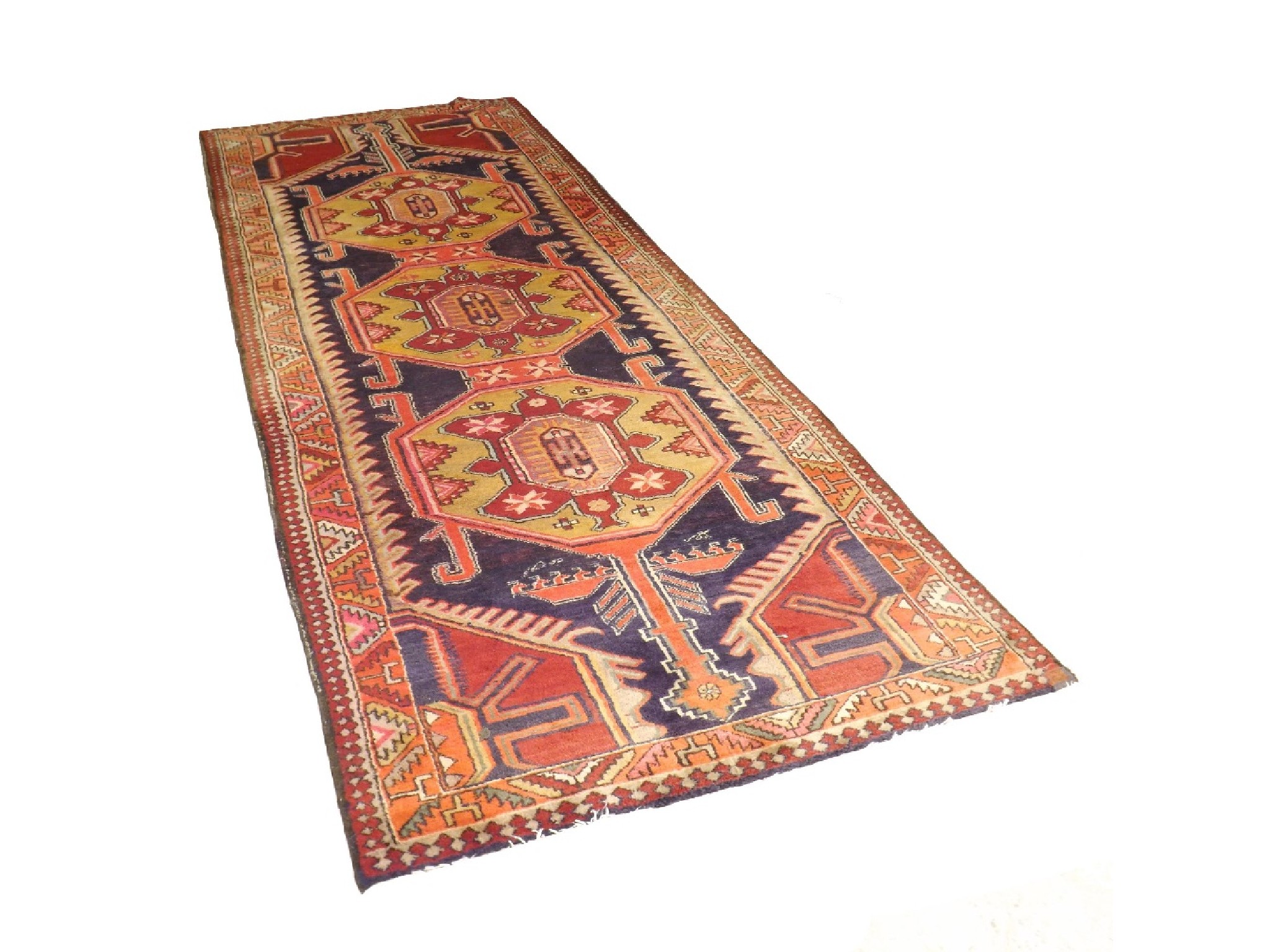 Appraisal: Large Afghan runner decorated with three colourful medallions upon a