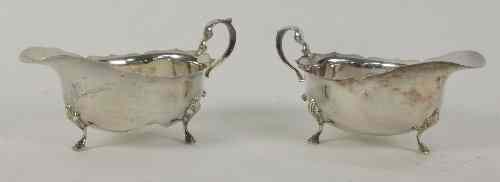 Appraisal: A pair of silver sauce boats Birmingham with scroll handles