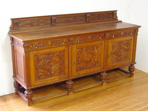 Appraisal: GRAND VICTORIAN OAK CARVED SIDEBOARD Light oak with heavy carved