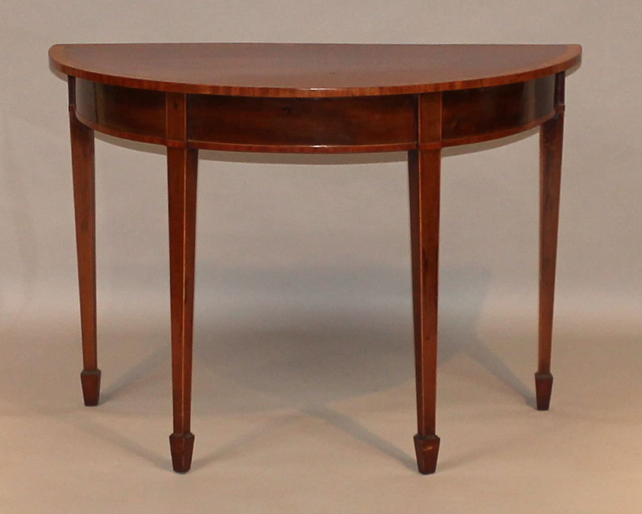 Appraisal: A thC mahogany D-end hall table the top with a