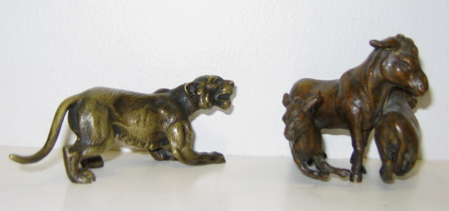 Appraisal: TWO AUSTRIAN CAST BRONZE SCULPTURES Miniature lion and three-piece group