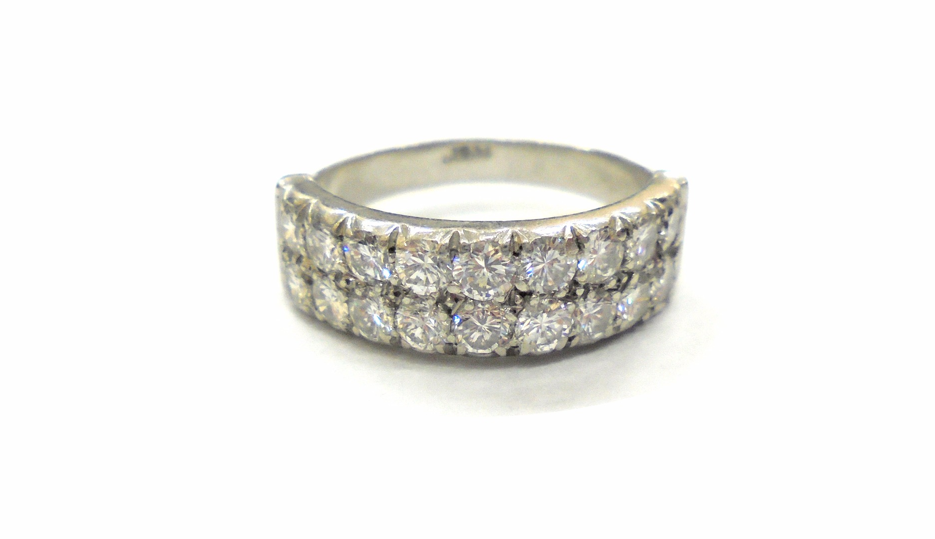 Appraisal: A platinum and diamond two row half eternity ring the