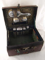 Appraisal: A leather cased locking dressing case with green watered silk