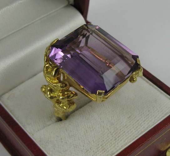 Appraisal: AMETHYST AND K GOLD RING set with a single emerald-cut