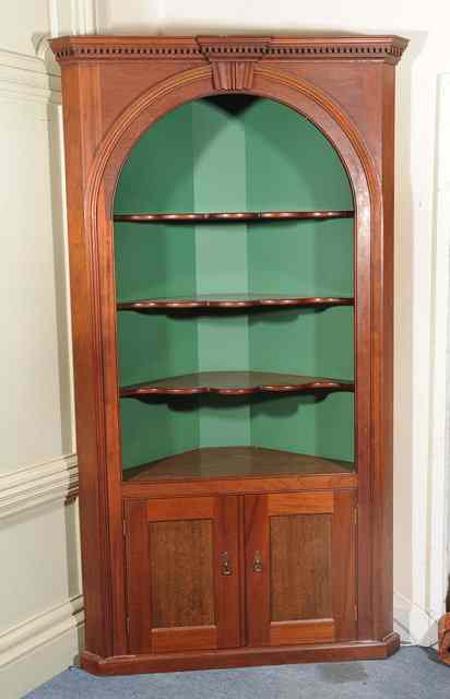 Appraisal: A GEORGIAN STYLE MAHOGANY CORNER FLOOR STANDING DISPLAY CABINET the