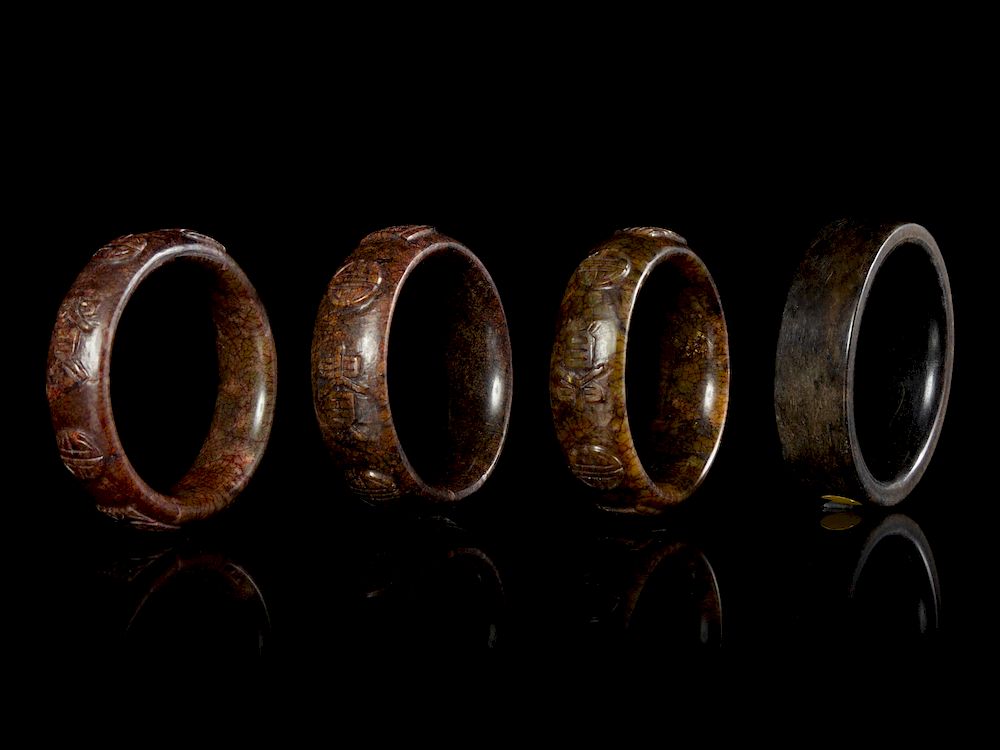 Appraisal: Four Chinese Jade Bangles Largest interior diam in cm Four