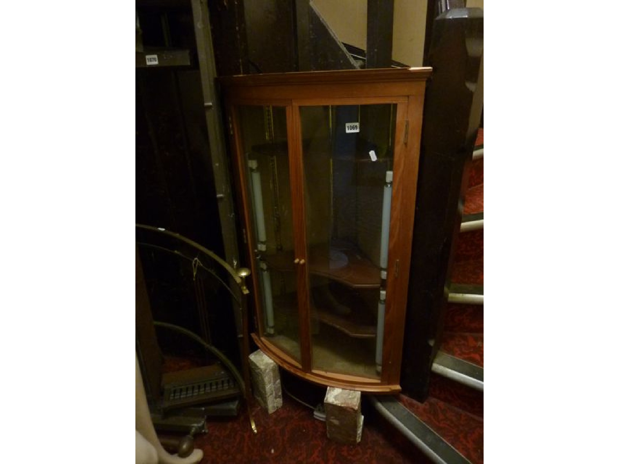 Appraisal: A polished pine freestanding bow fronted corner cupboard enclosed by