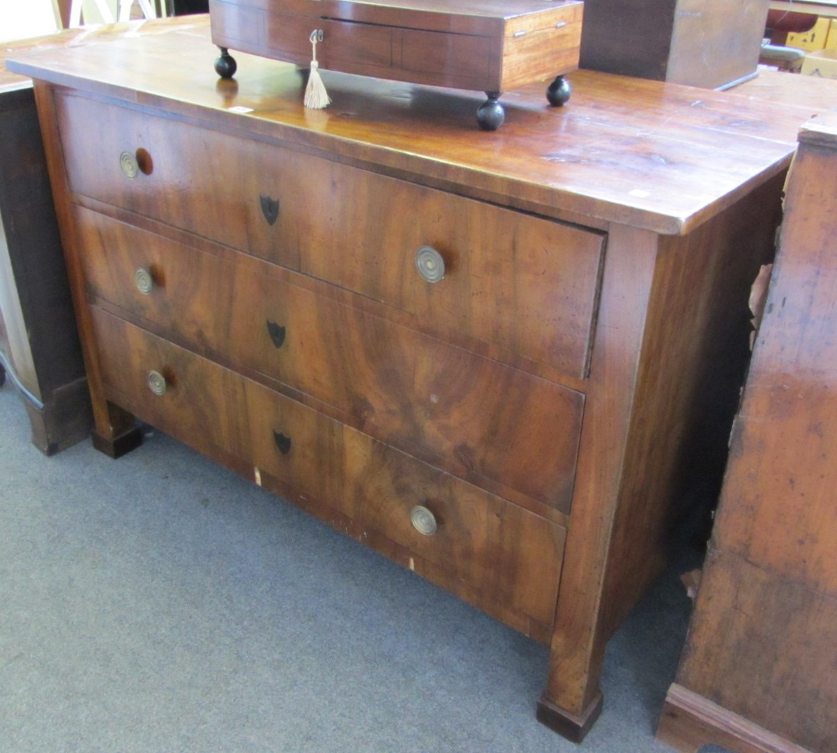 Appraisal: A Biedermeier walnut straight front three drawer commode on block