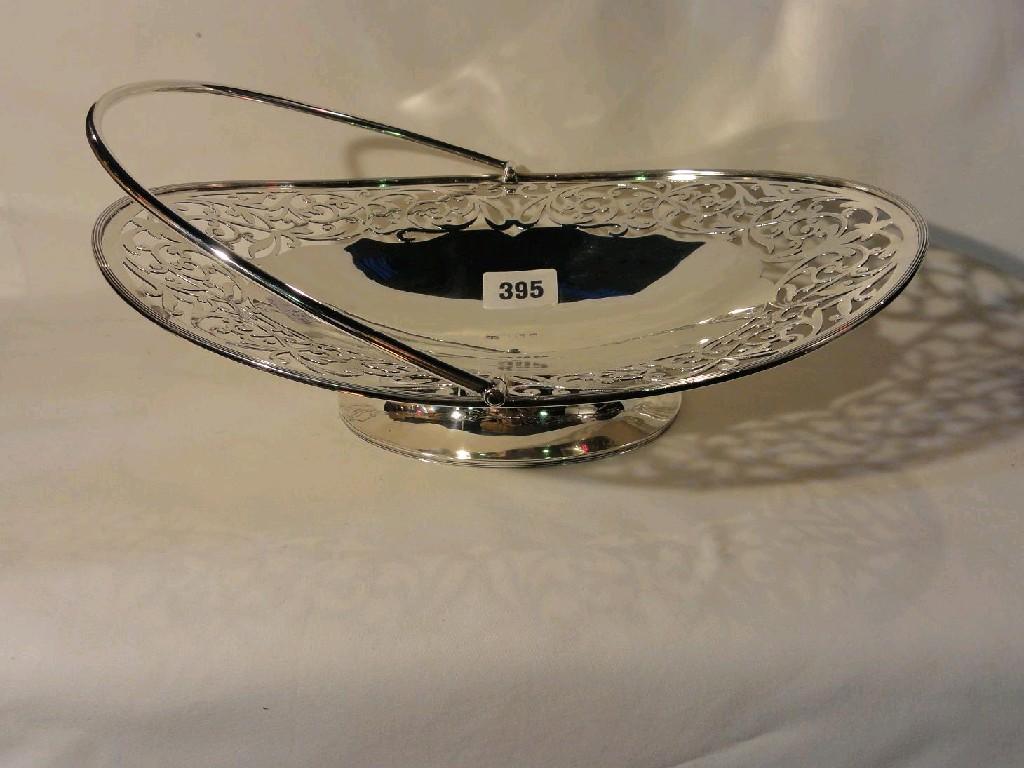 Appraisal: An oval silver basket with pierced and scrolling border decoration