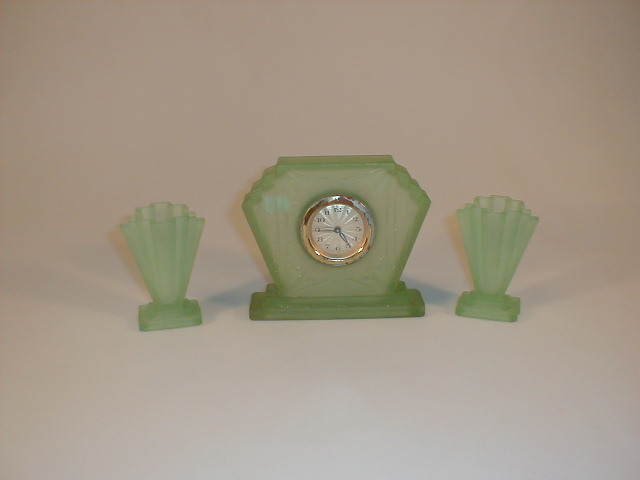 Appraisal: An Art Deco green frosted glass clock garniture the clock