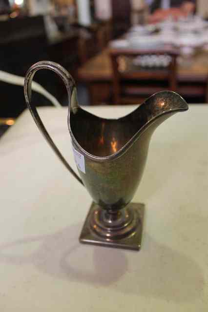 Appraisal: A GEORGIAN HELMET SHAPED MILK JUG with loop handle and