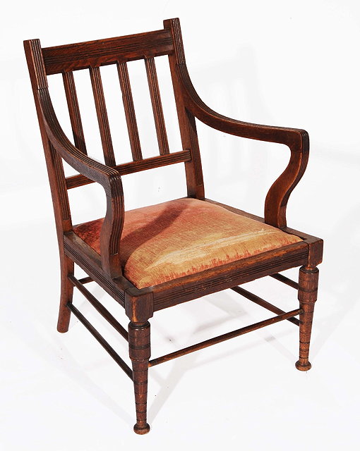 Appraisal: AN ARTS AND CRAFTS OAK ELBOW CHAIR with rail back