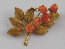 Appraisal: An carat gold brooch set with coral carved as roses