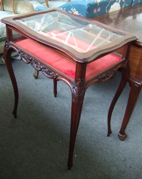 Appraisal: A th century mahogany framed vertu table the shaped top