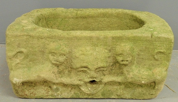 Appraisal: - Ancient stone watering trough with relief carved mask flanked