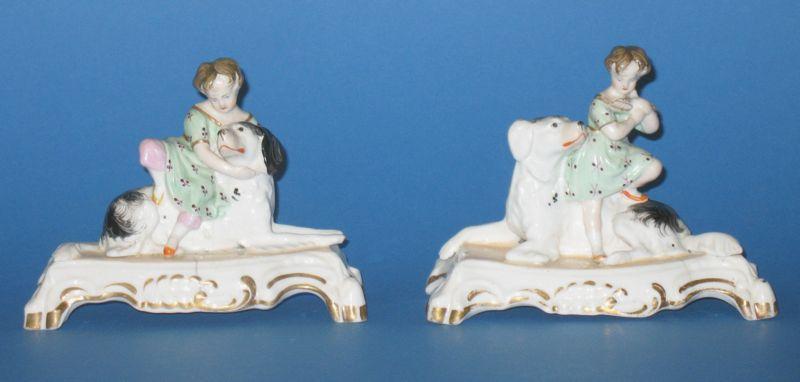 Appraisal: A PAIR OF STAFFORDSHIRE PORCELAIN MODELS OF CHILDREN AND DOGS