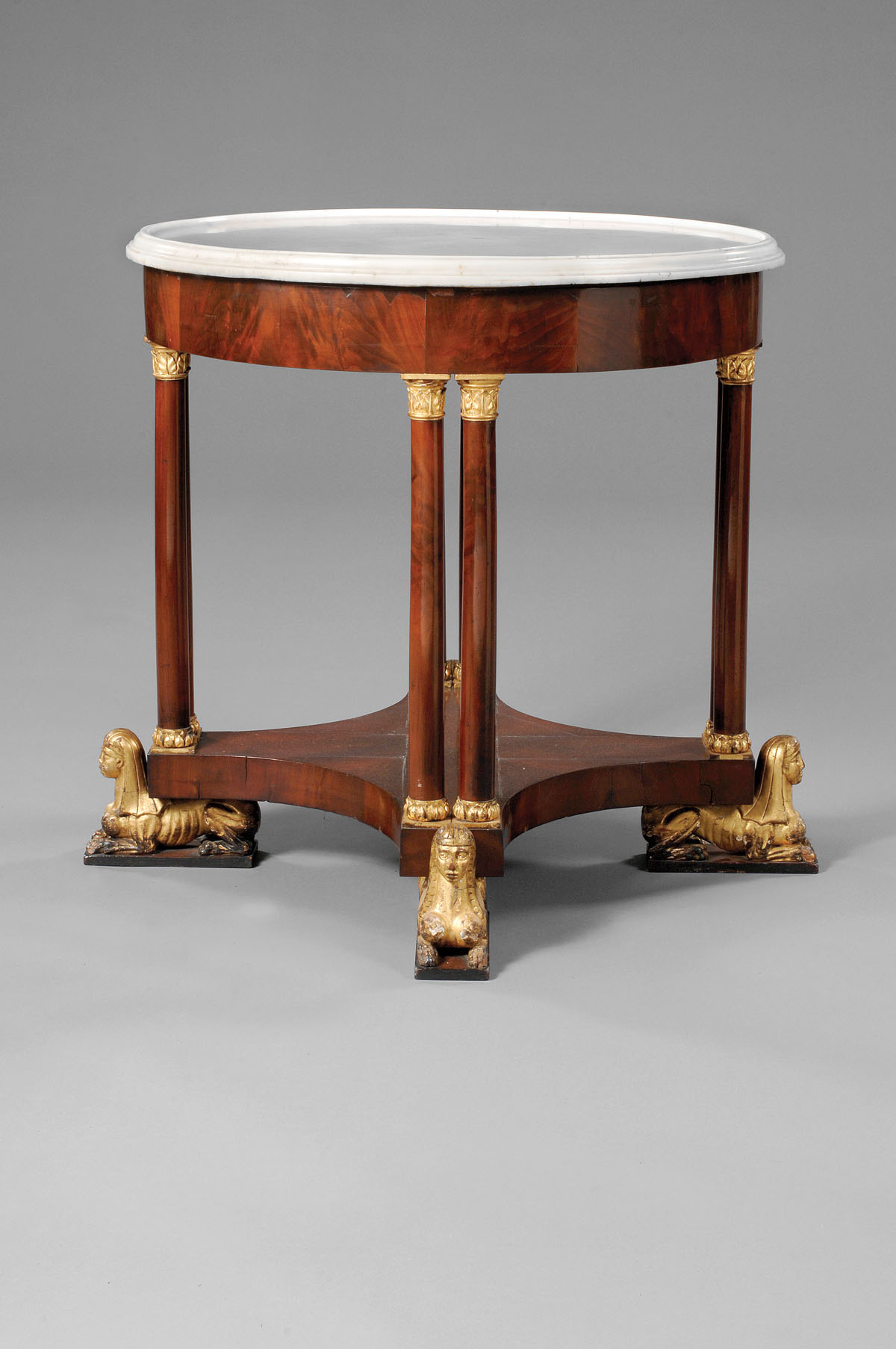 Appraisal: AMERICAN EGYPTIAN REVIVAL MAHOGANY MARBLE TOP CENTER TABLE The dish