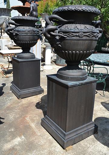 Appraisal: A PAIR OF BRONZE PATINATED COMPOSITE MEDUSA URNS ON STANDS