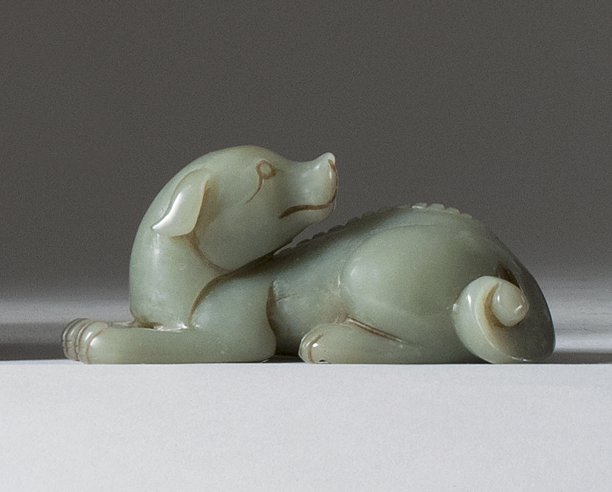 Appraisal: CELADON JADE CARVING In the form of a reclining dog