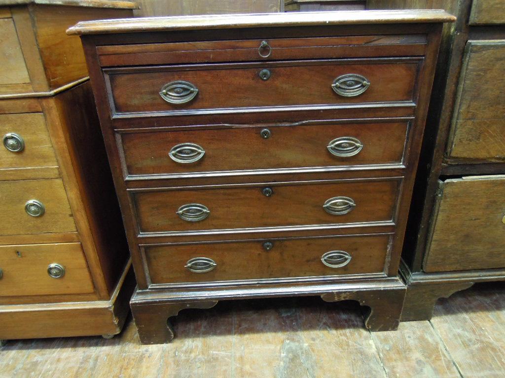 Appraisal: A small th century mahogany chest with brushing slide over