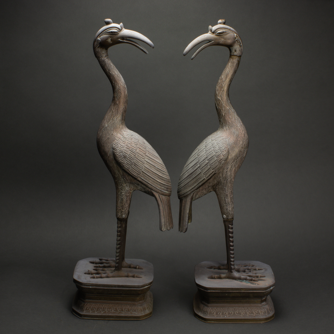 Appraisal: Pair of Japanese bronze cranes each shown standing on a