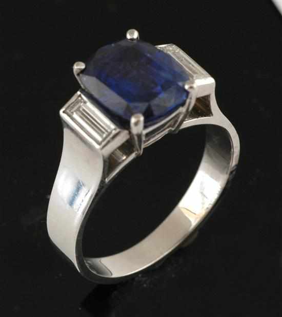 Appraisal: A three stone sapphire and diamond ring Centrally set with