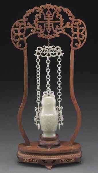 Appraisal: Chinese white jade chain hanging vasedepicting the face of the