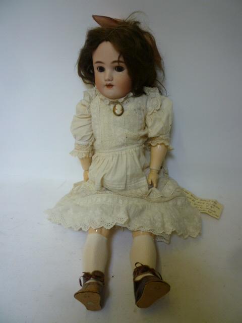 Appraisal: A Heinrich Handwerck bisque head girl doll with brown glass