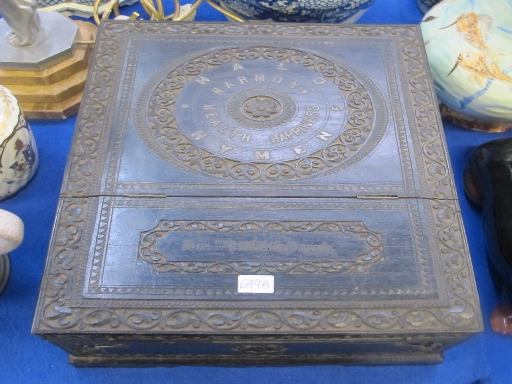 Appraisal: Ebonised travelling box the outside carved and with metal lettering