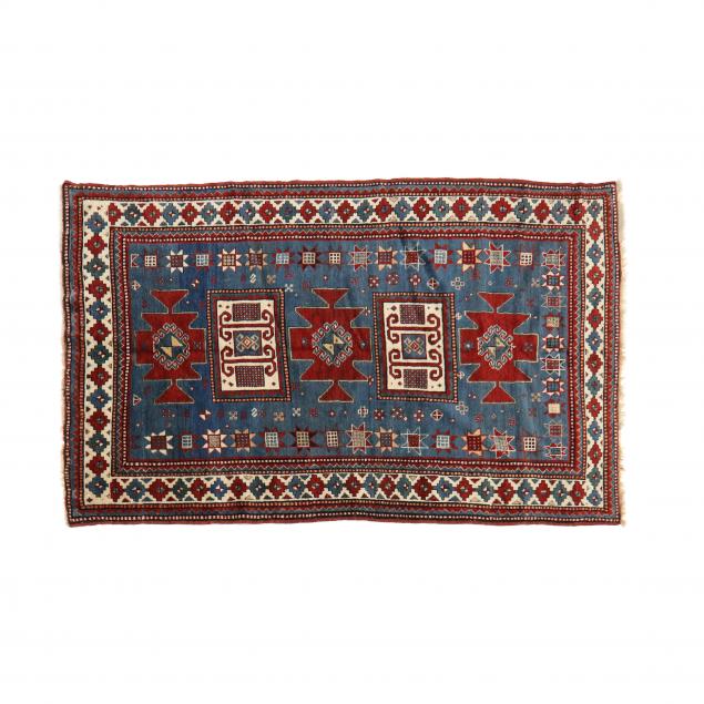 Appraisal: KAZAK AREA RUG Blue field with rectangular and geometric medallions