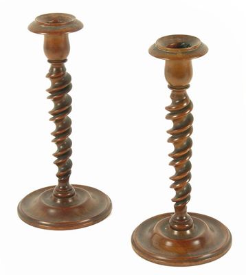 Appraisal: A pair of th century turned olive wood candlesticks spiral