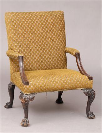 Appraisal: GEORGE II CARVED MAHOGANY LIBRARY ARMCHAIR With padded back armrests