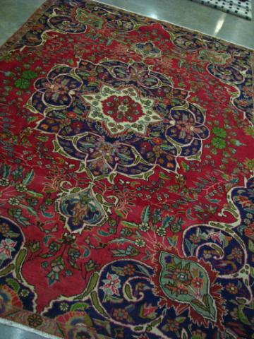 Appraisal: x Tabriz rug red field with cream navy and green